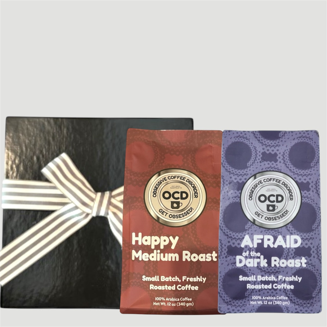 Two coffee packages with a decorative bow on a light gray background