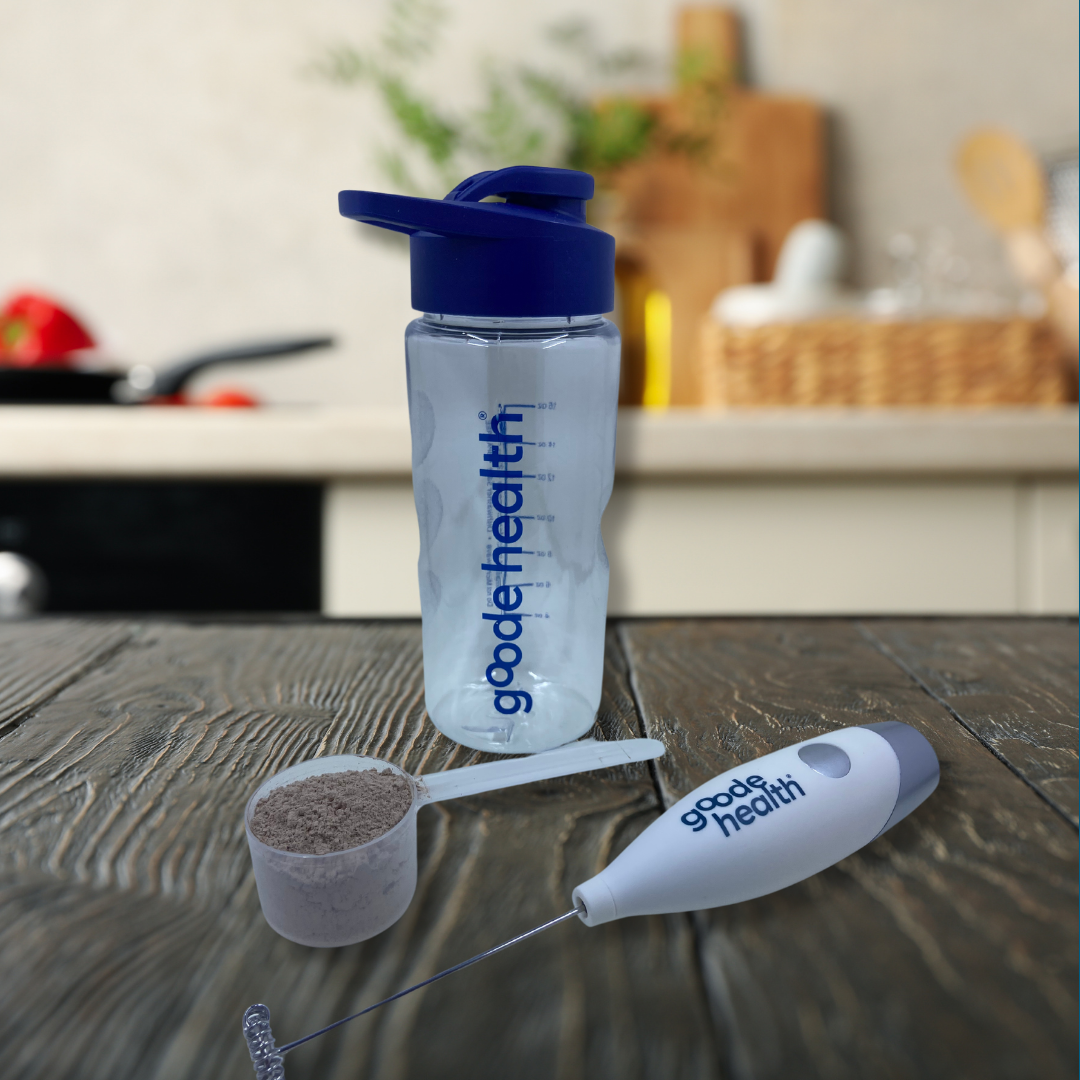 Clear water bottle with blue cap and 'goode health' branding on a wooden surface.