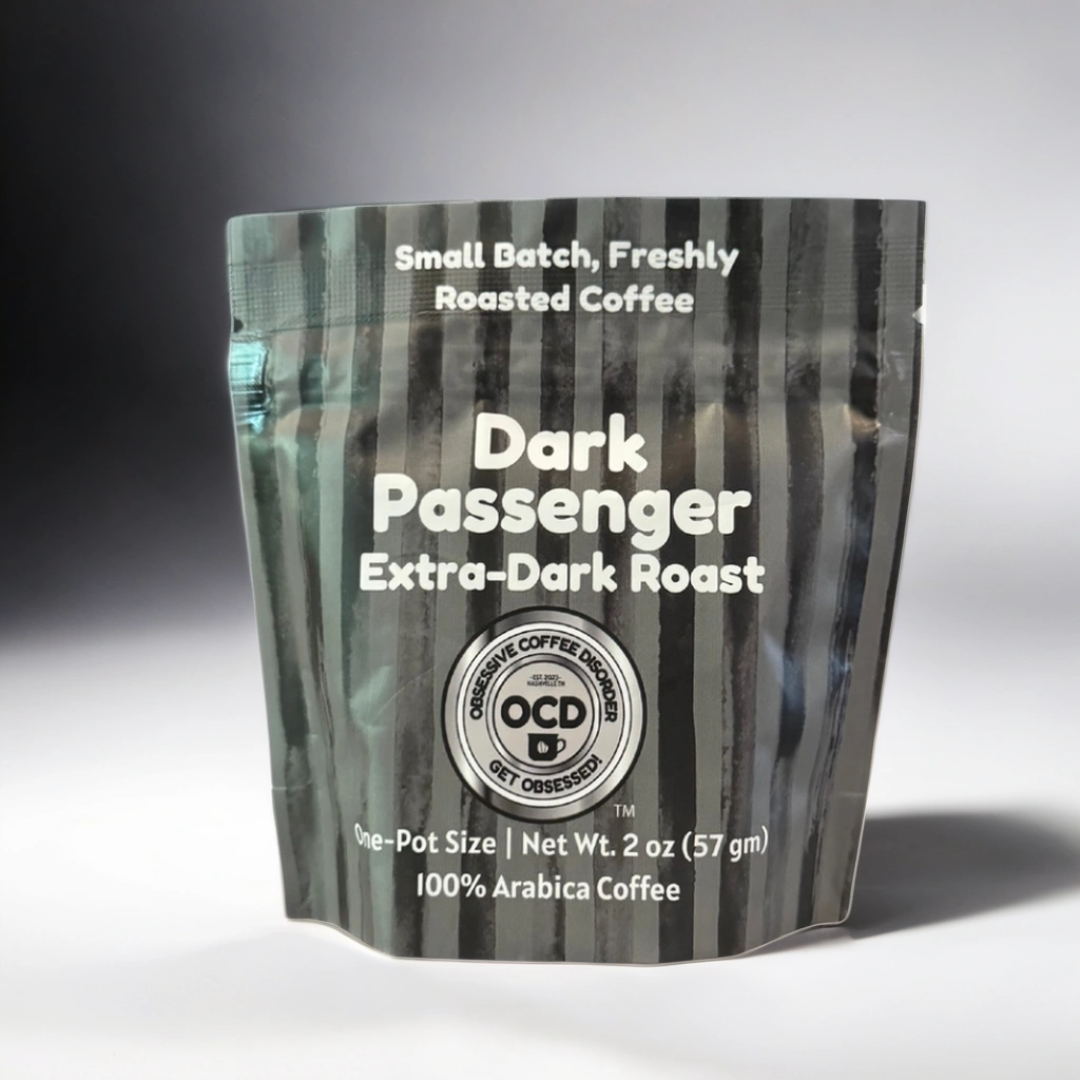 Coffee package labeled 'Dark Passenger Extra-Dark Roast' by OCD Coffee on a gray background