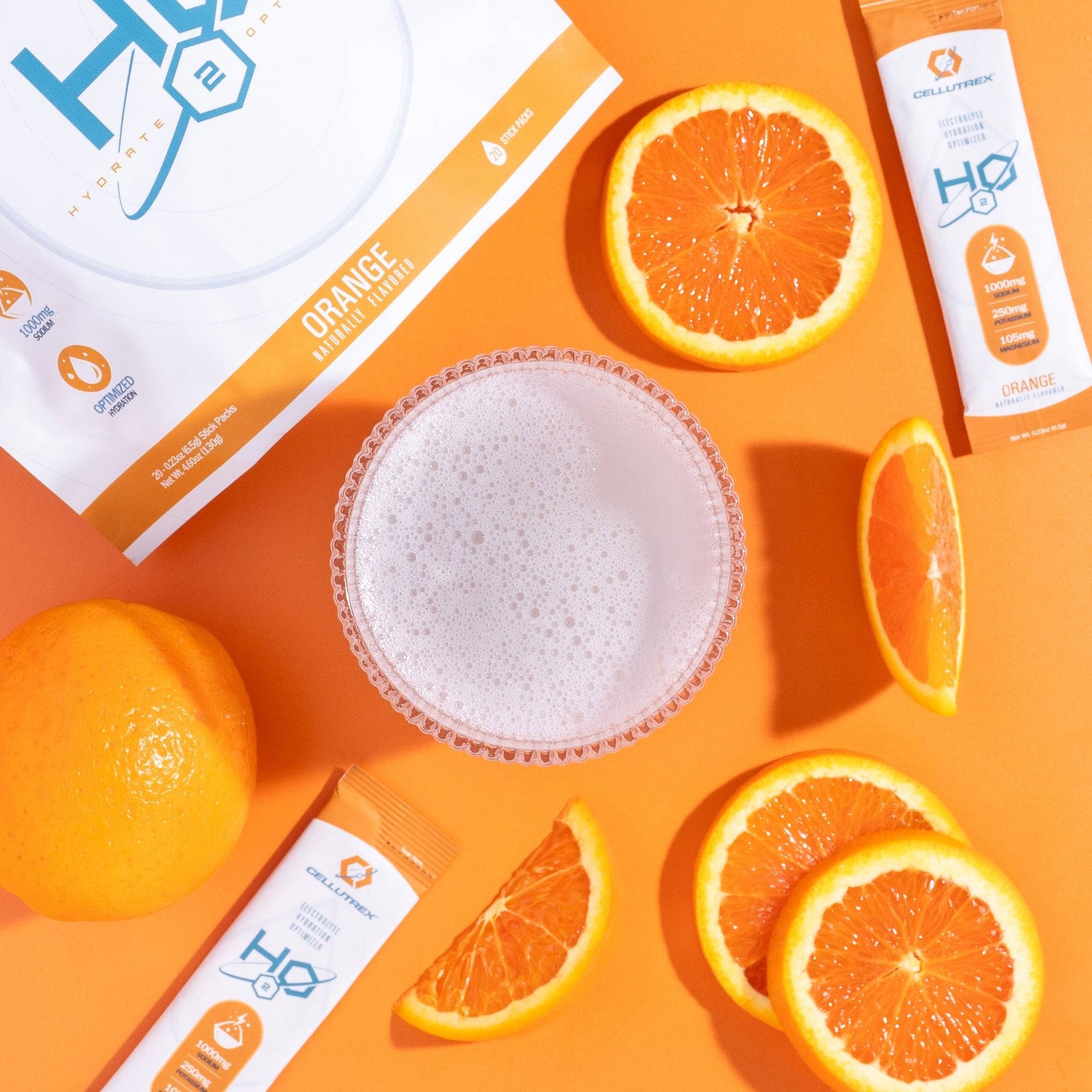 Orange-flavored supplement packets with oranges on an orange background