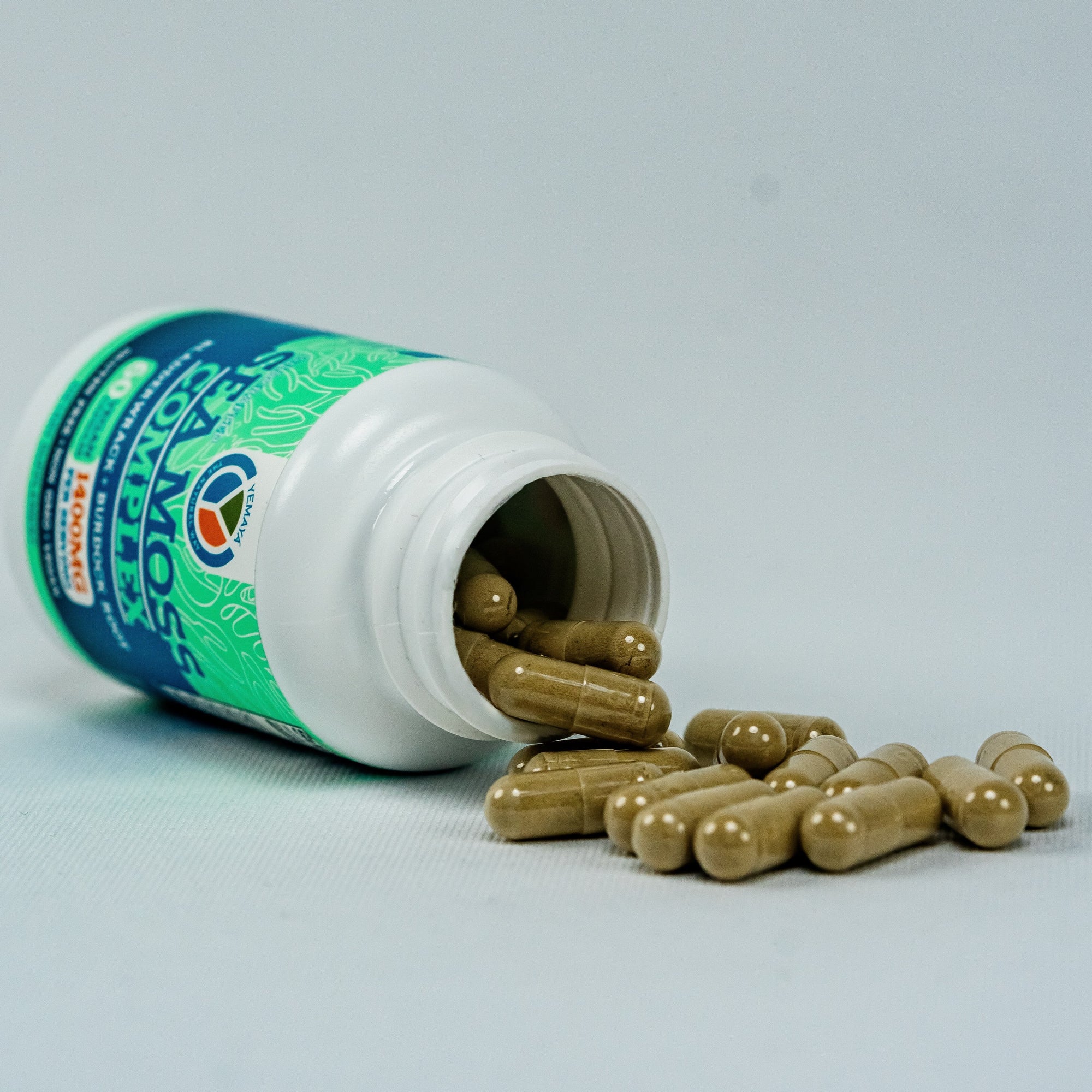 Open bottle of capsules with visible label on a light gray background