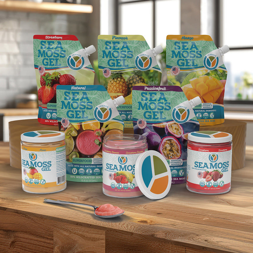 Assorted packages of Sea Moss Gel on a wooden surface with a blurred kitchen background.