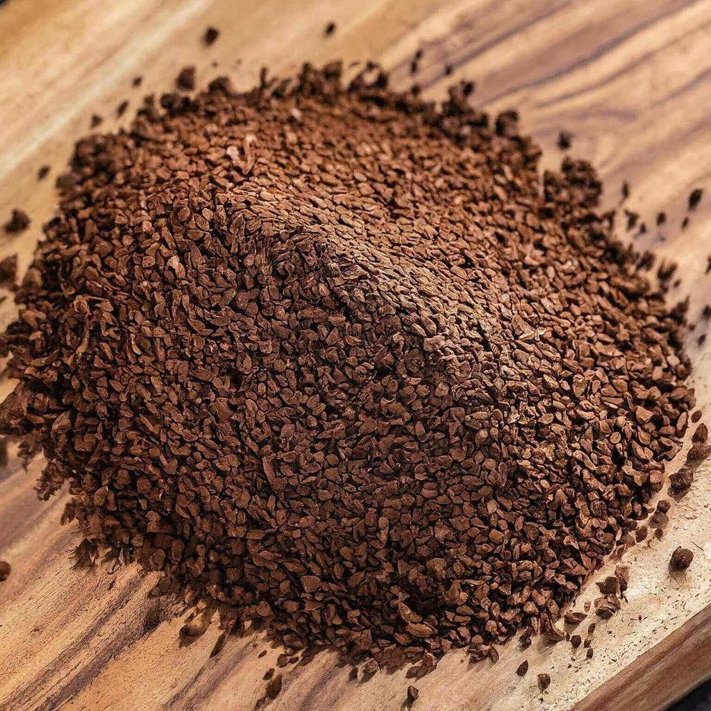 Close-up of ground coffee on a wooden surface