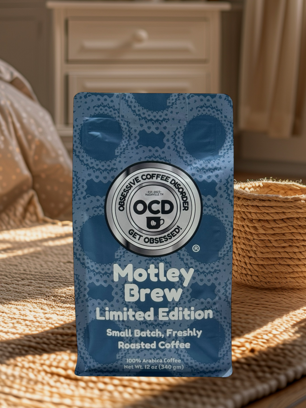 Blue coffee package labeled 'Motley Brew' by OCD Coffee on a woven surface.