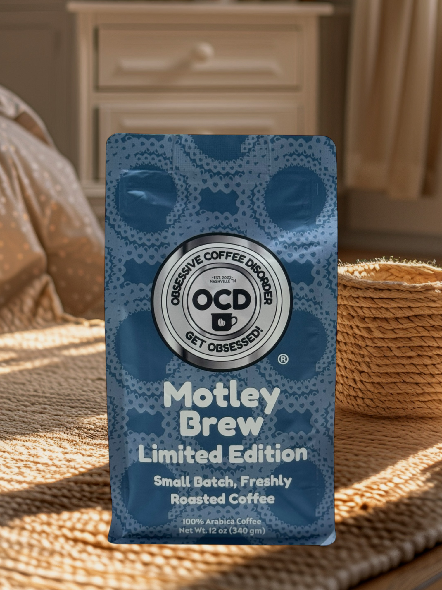 Blue coffee package labeled 'Motley Brew' by OCD Coffee on a woven surface.