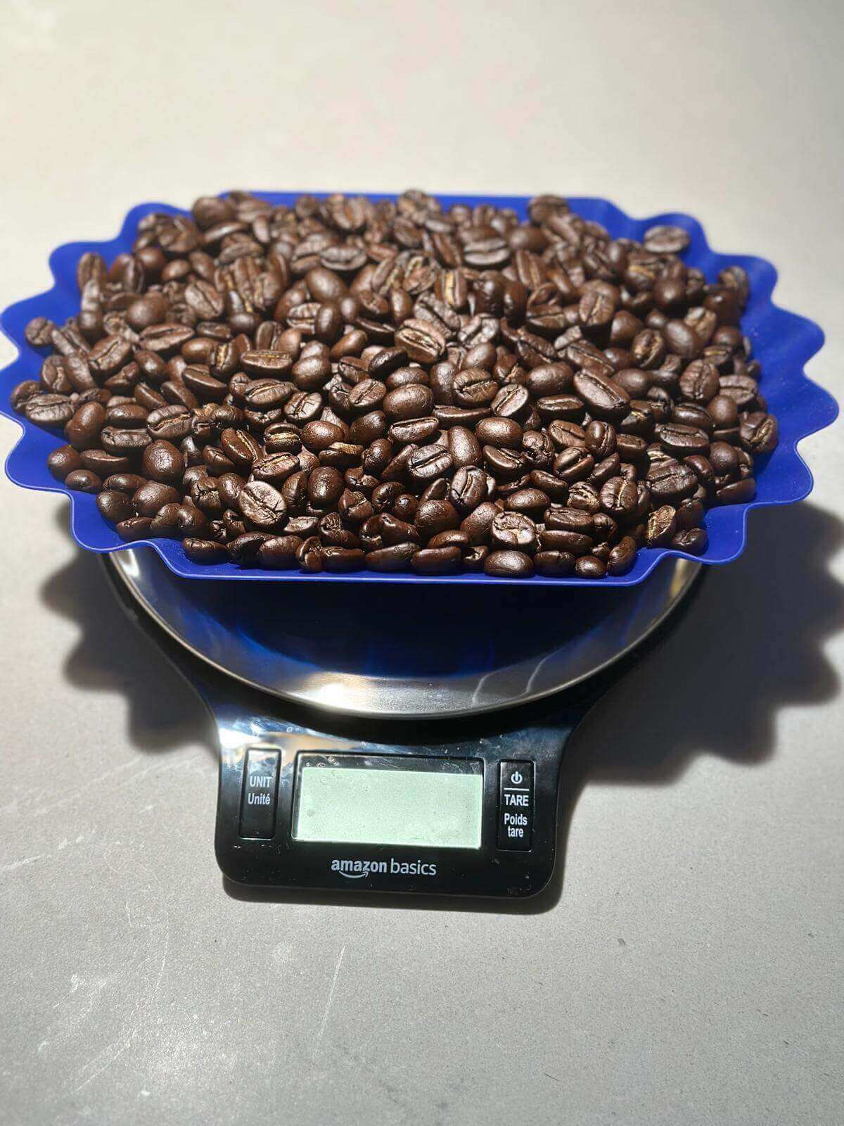 Coffee beans on a blue scale with an Amazon Basics label.