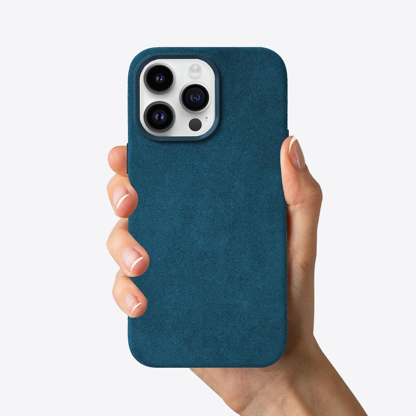 Hand holding a blue phone case against a white background