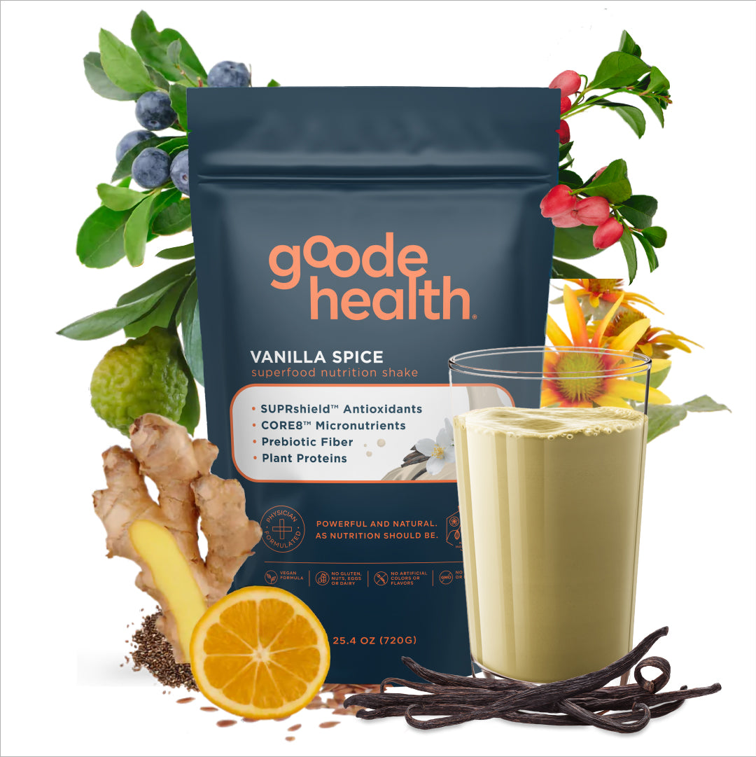 goode health vanilla spice superfood nutrition shake package with a glass of shake, ginger, orange, and vanilla beans on a white background.